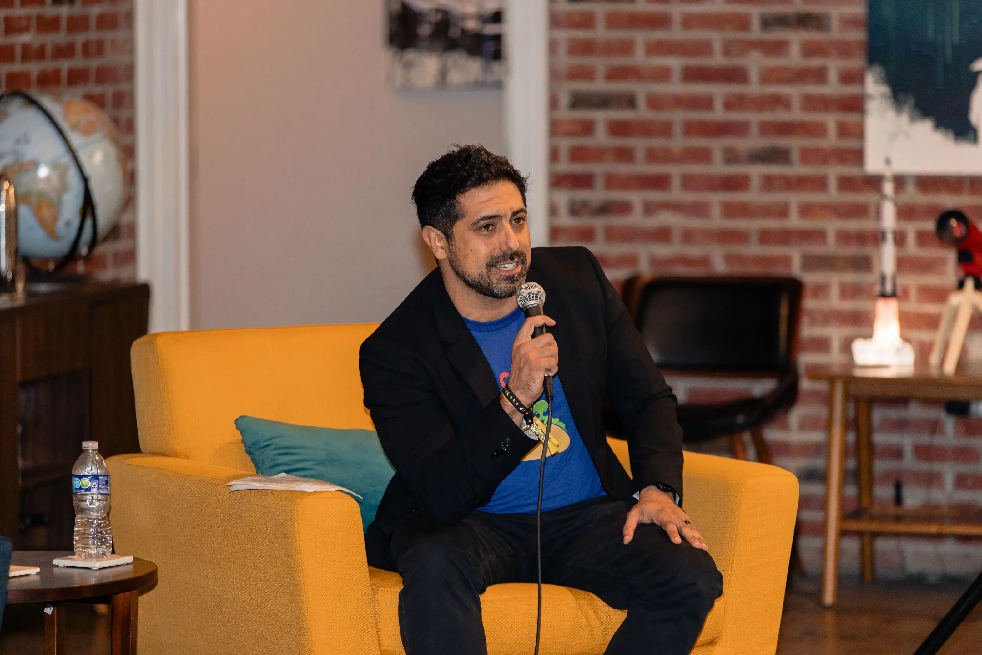 Speaker presenting from yellow chair at TechFest 2024